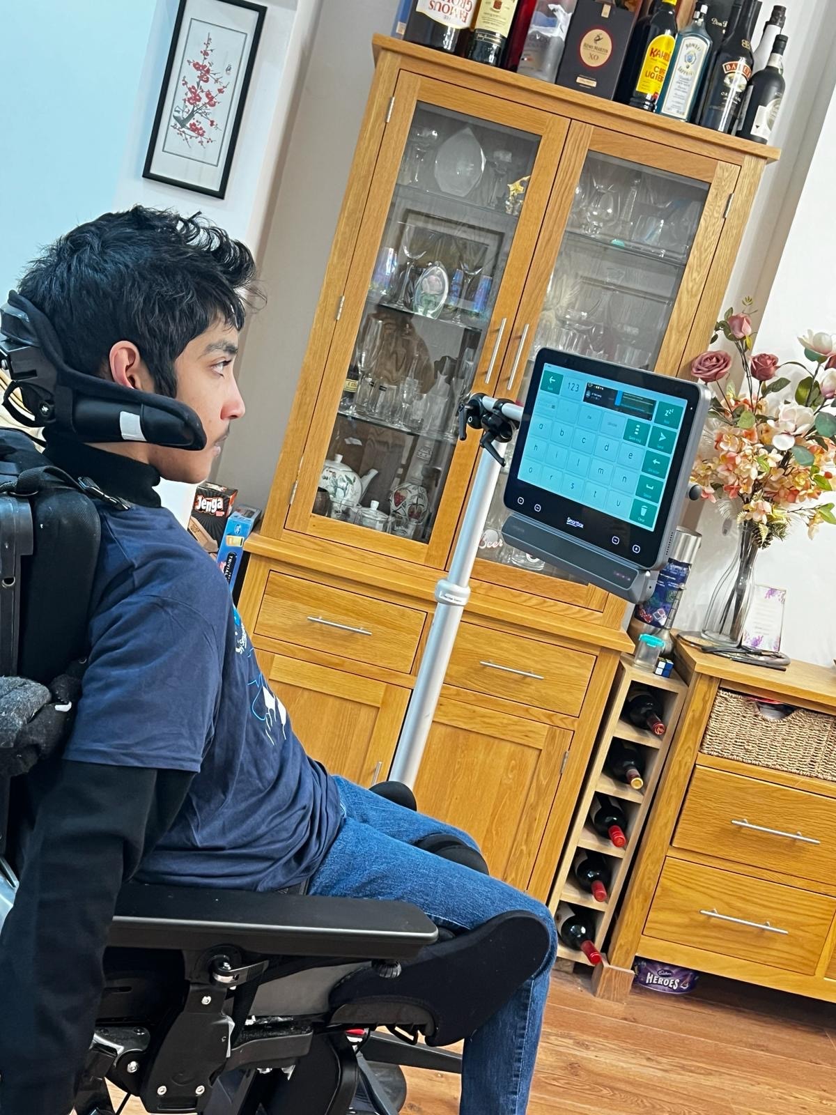 Person using an assistive communication device